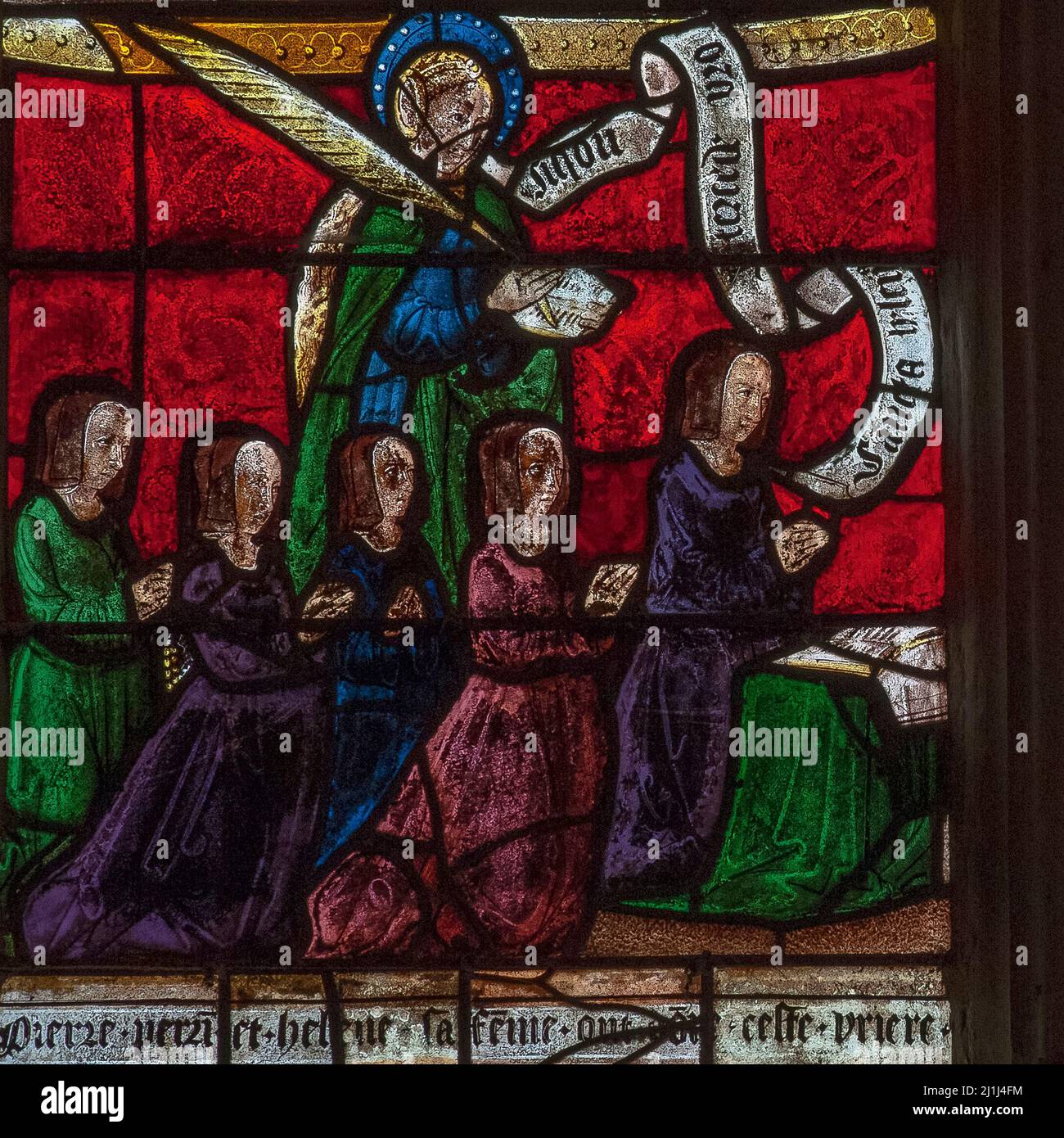 Preserved in Renaissance stained glass: female members of the 16th century French family donors of a Passion of Christ window in the Église Saint-Rémi at Ceffonds, a Haute-Marne village in Champagne region, depicted kneeling in prayer with Saint Helen. Stock Photo