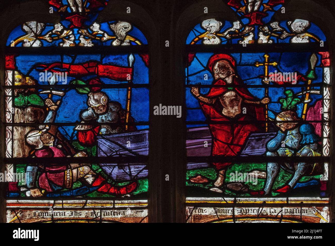 Roman guards reel in shock and disbelief as Jesus steps out of his tomb on the third day after his crucifixion: two panels of colourful Renaissance stained glass in 16th century Resurrection window in the Église Saint-Rémi at Ceffonds, in the Haute-Marne of the Champagne region of northeast France. Stock Photo