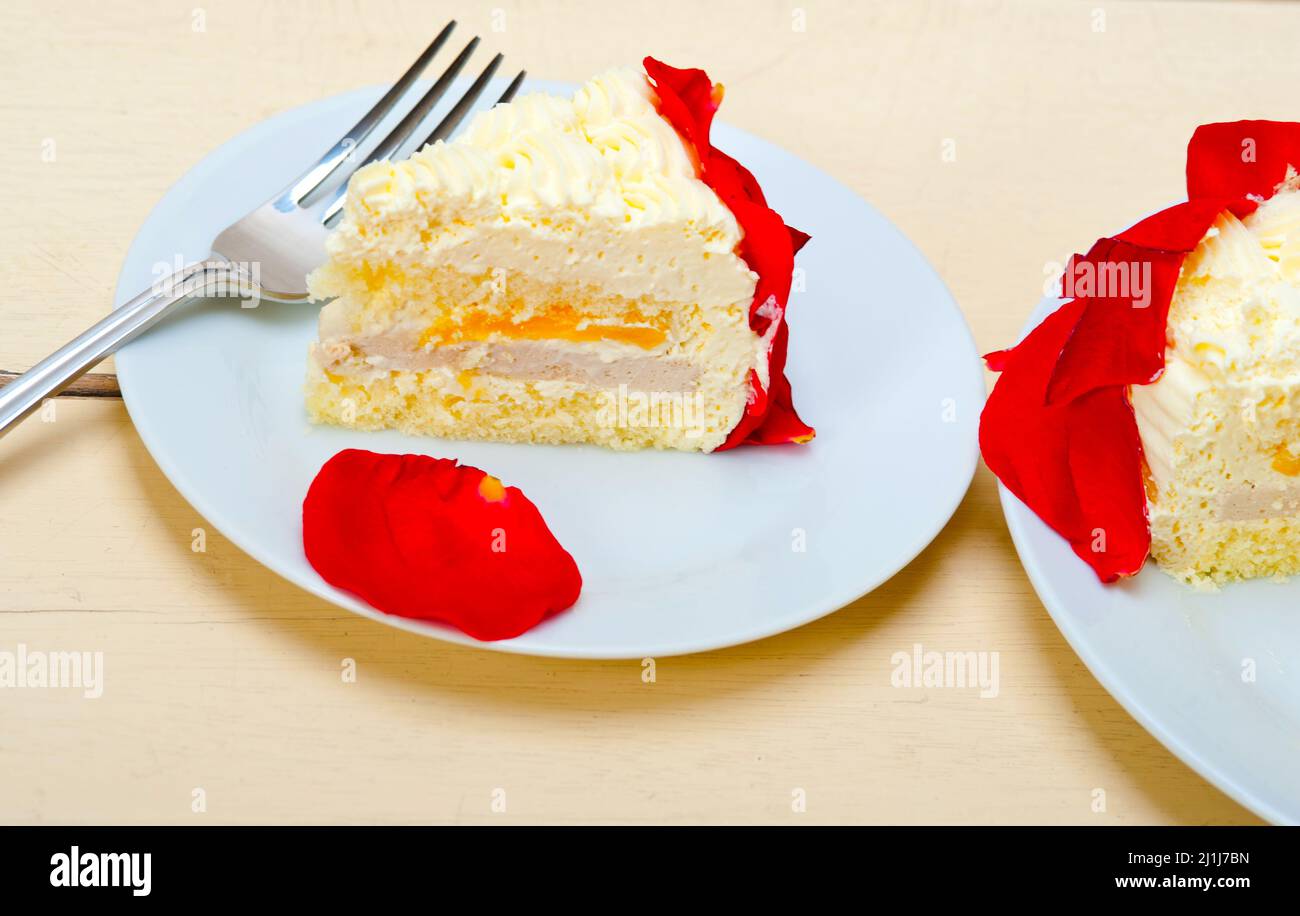 whipped cream mango cake with red rose petals Stock Photo Alamy