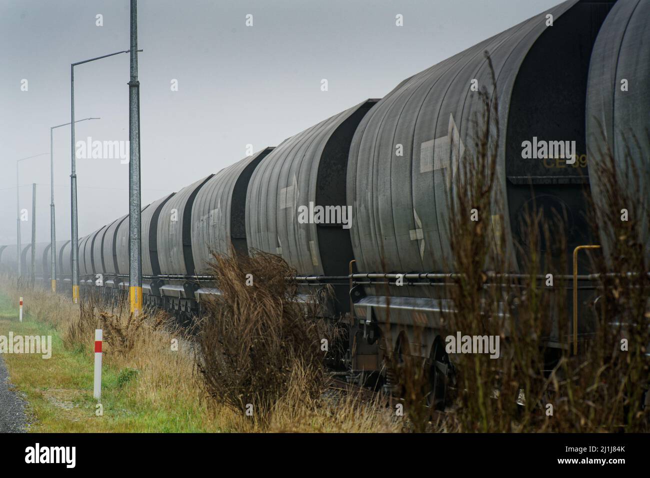 Arthur's Pass/New Zealand, March 5, 2022: A long train of railway trucks carrying coal in Arthur's Pass. Stock Photo