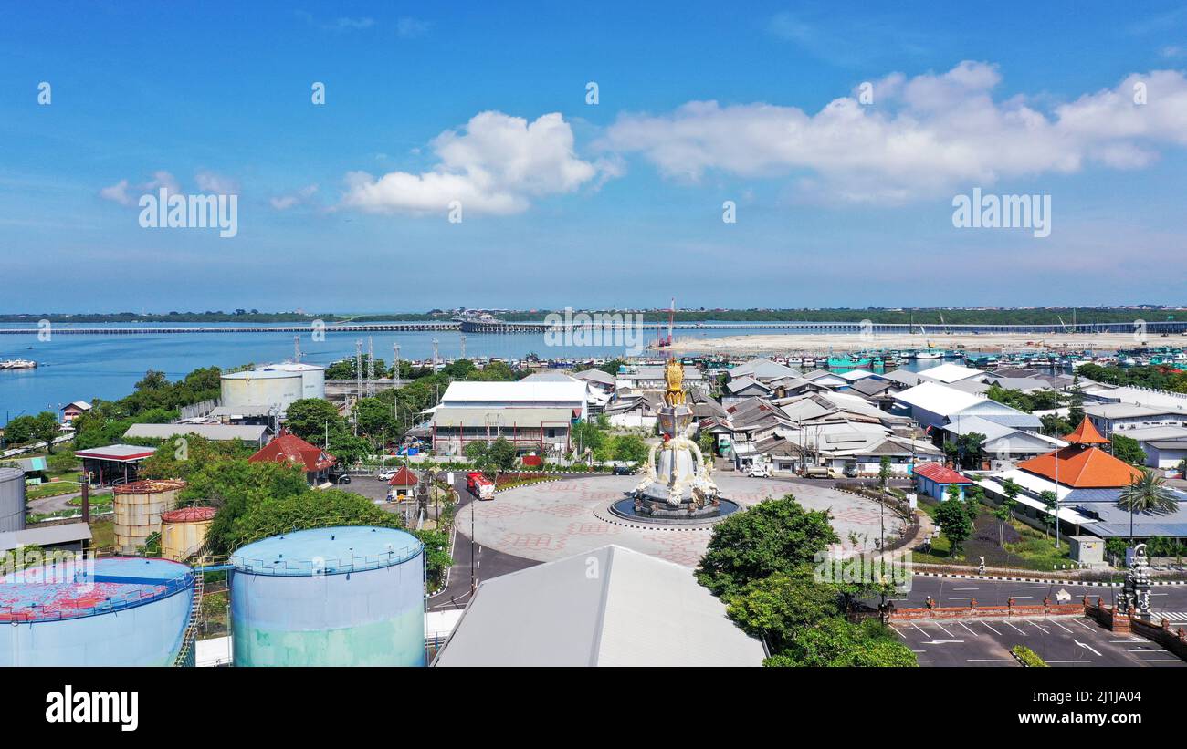 Aerial container terminal of Benoa Harbour with stacks of the boxes and a red command tower under light blue sky Stock Photo