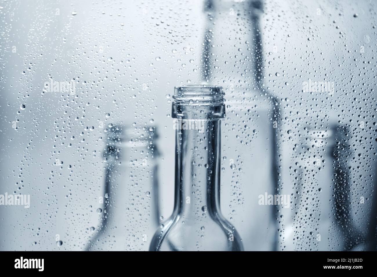 Glass transparent bottles in water drops. Glass dishes Stock Photo Alamy