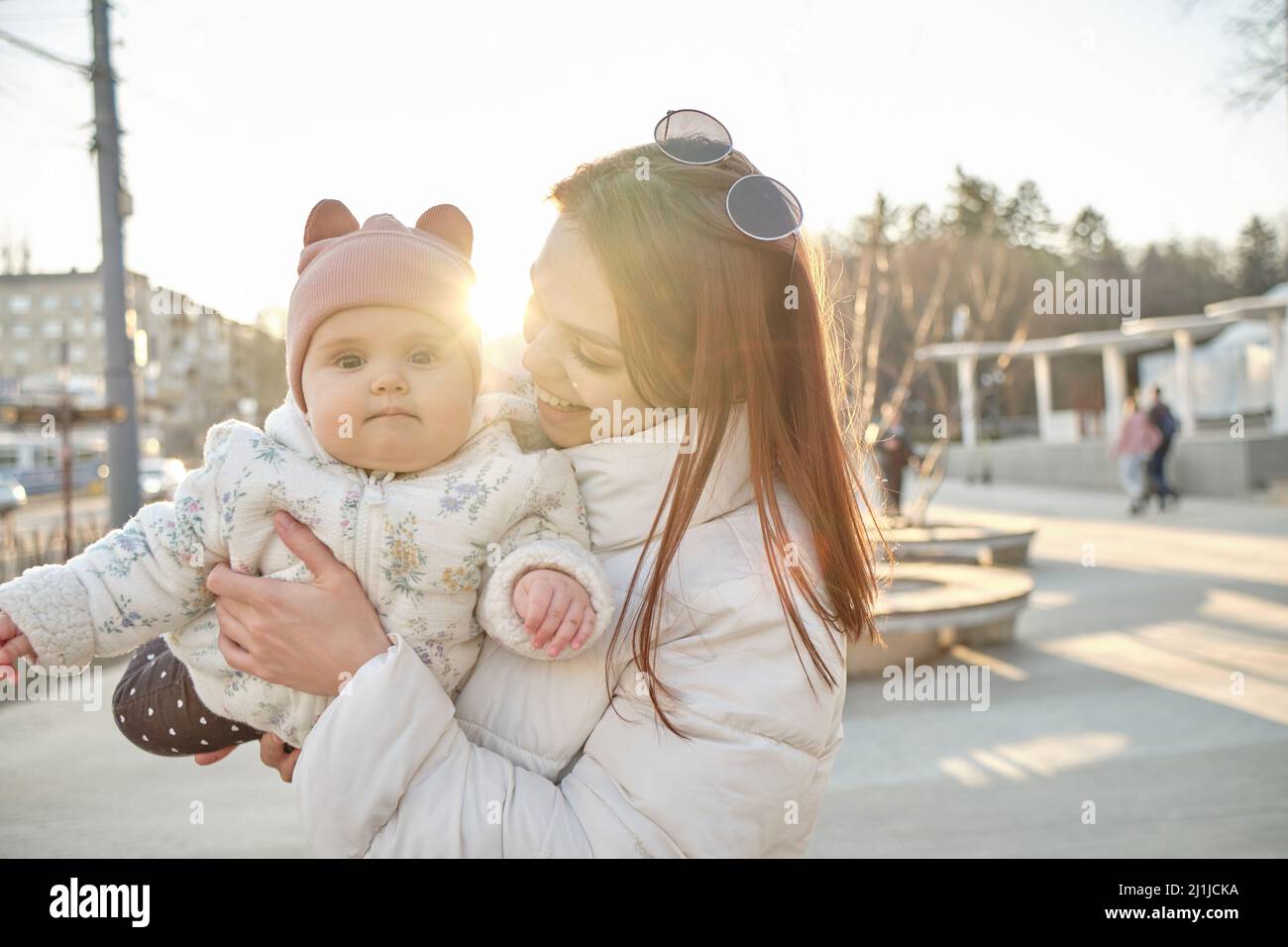 happy harmonious family outdoors. mother throws baby up, laughing and