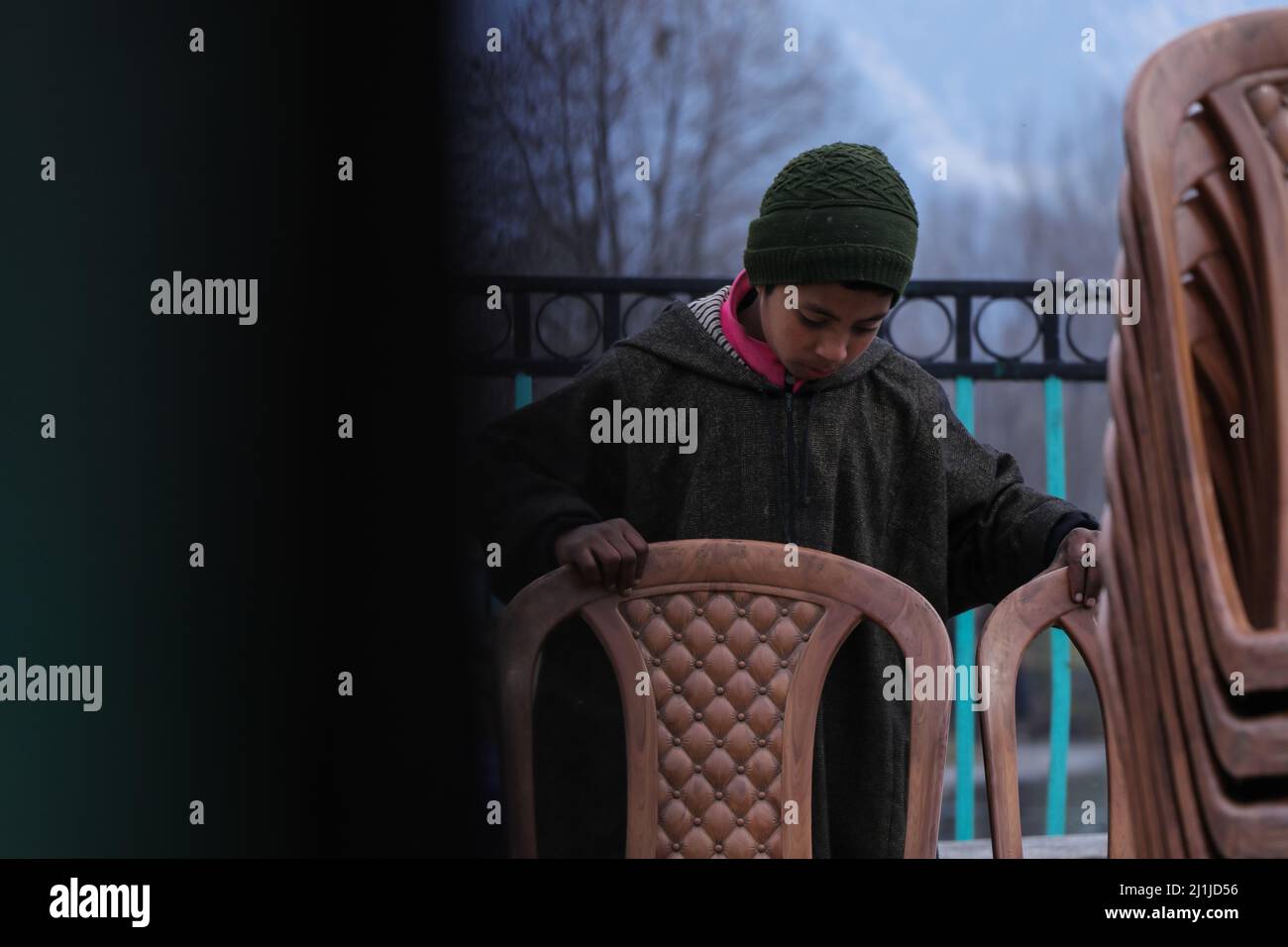 Kashmir, India. 26th Mar, 2022. March 26, 2022, Srinagar, Jammu and Kashmir, India: A child places chairs at a roadside hotel in Srinagar on March 26, 2022. According to a 2018 report by the International Labour Organization (ILO), the number of child labourers around the world fell from 246 million in 2000 to around 152 million in 2016. However, millions of children continue to be exploited for cheap labour, especially in countries such as India. Credit: ZUMA Press, Inc./Alamy Live News Stock Photo