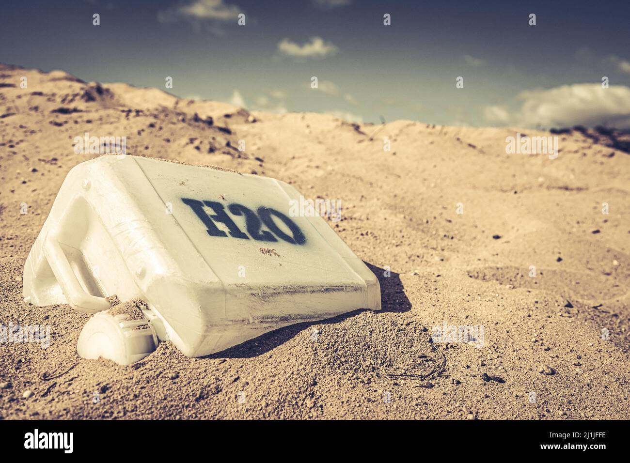 Plastic water cans in danger and toxic desert. Empty plastic water cans