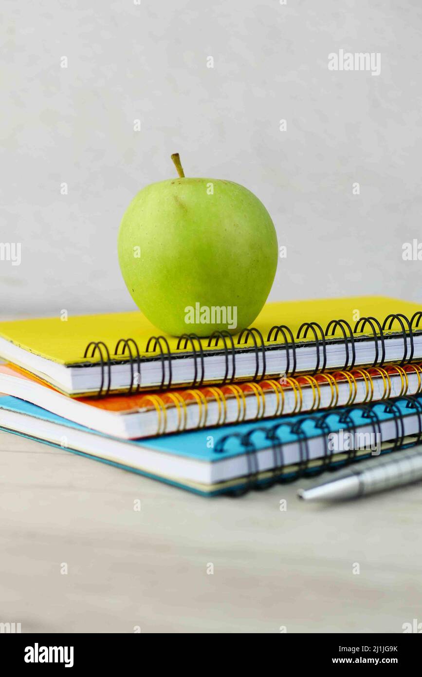 black to school concept with apple on notepad on table. Stock Photo