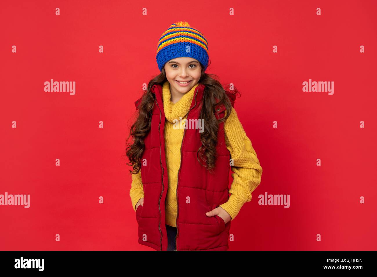 winter fashion. happy kid with curly hair in hat. female fashion model ...
