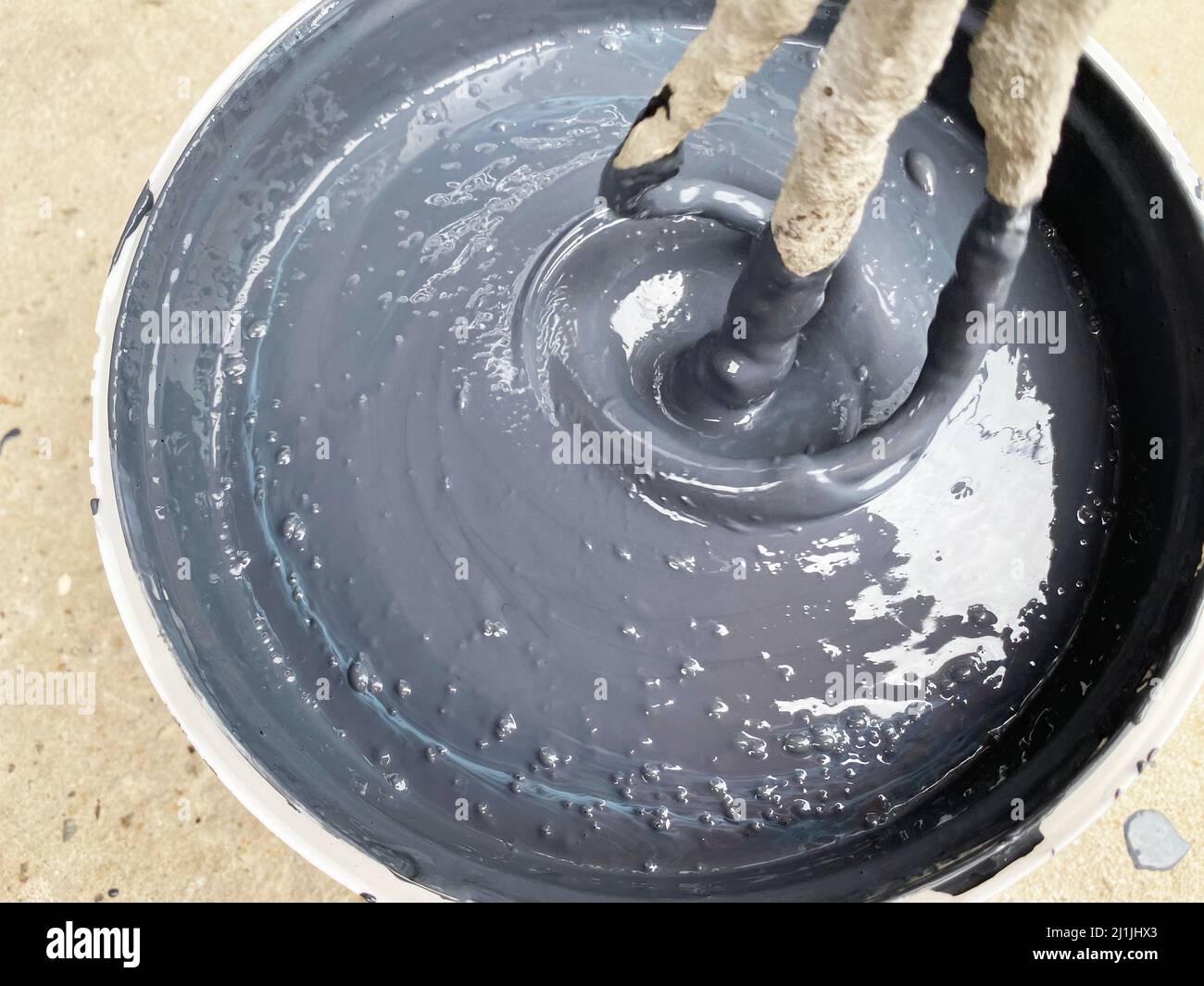 Building mixer for mixing paint. Mixing process Stock Photo Alamy