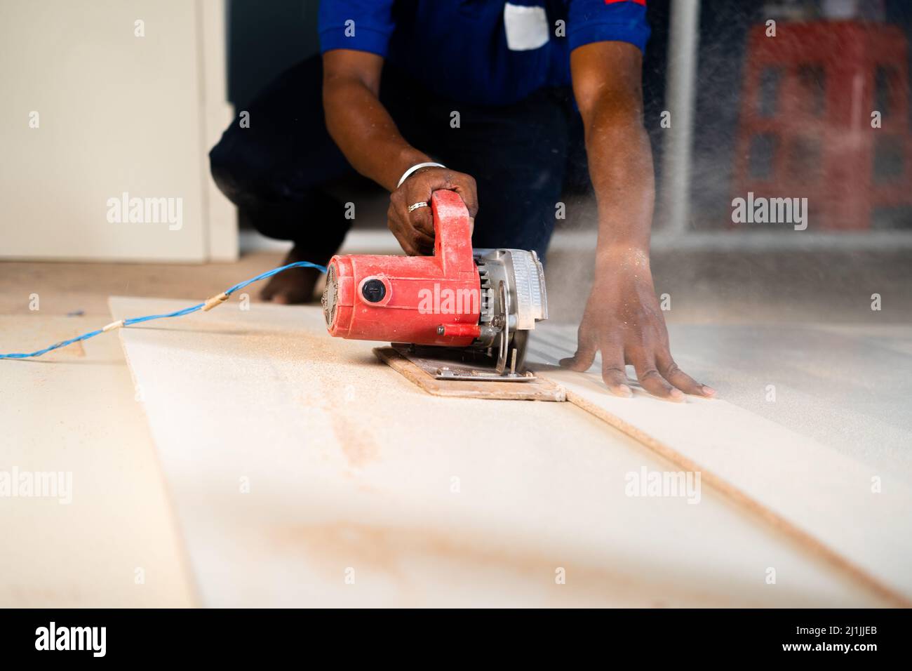 Close shot of carpenter or wood worker cutting wood by using circular saw machine at workplace - concept of hard wood working, renovation and skilled Stock Photo