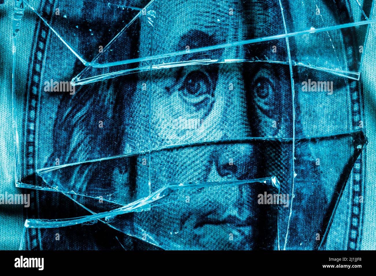 shards of glass on a portrait of Benjamin Franklin on a dollar bill. High quality photo Stock Photo