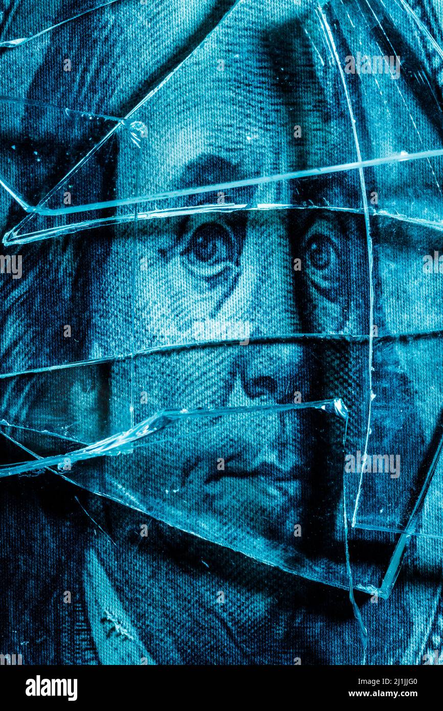 shards of glass on a portrait of Benjamin Franklin on a dollar bill. High quality photo Stock Photo