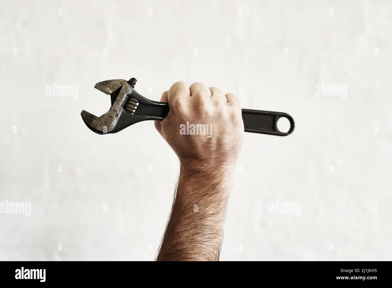 The all powerful monkey wrench. Shot of an unrecognizable handyman