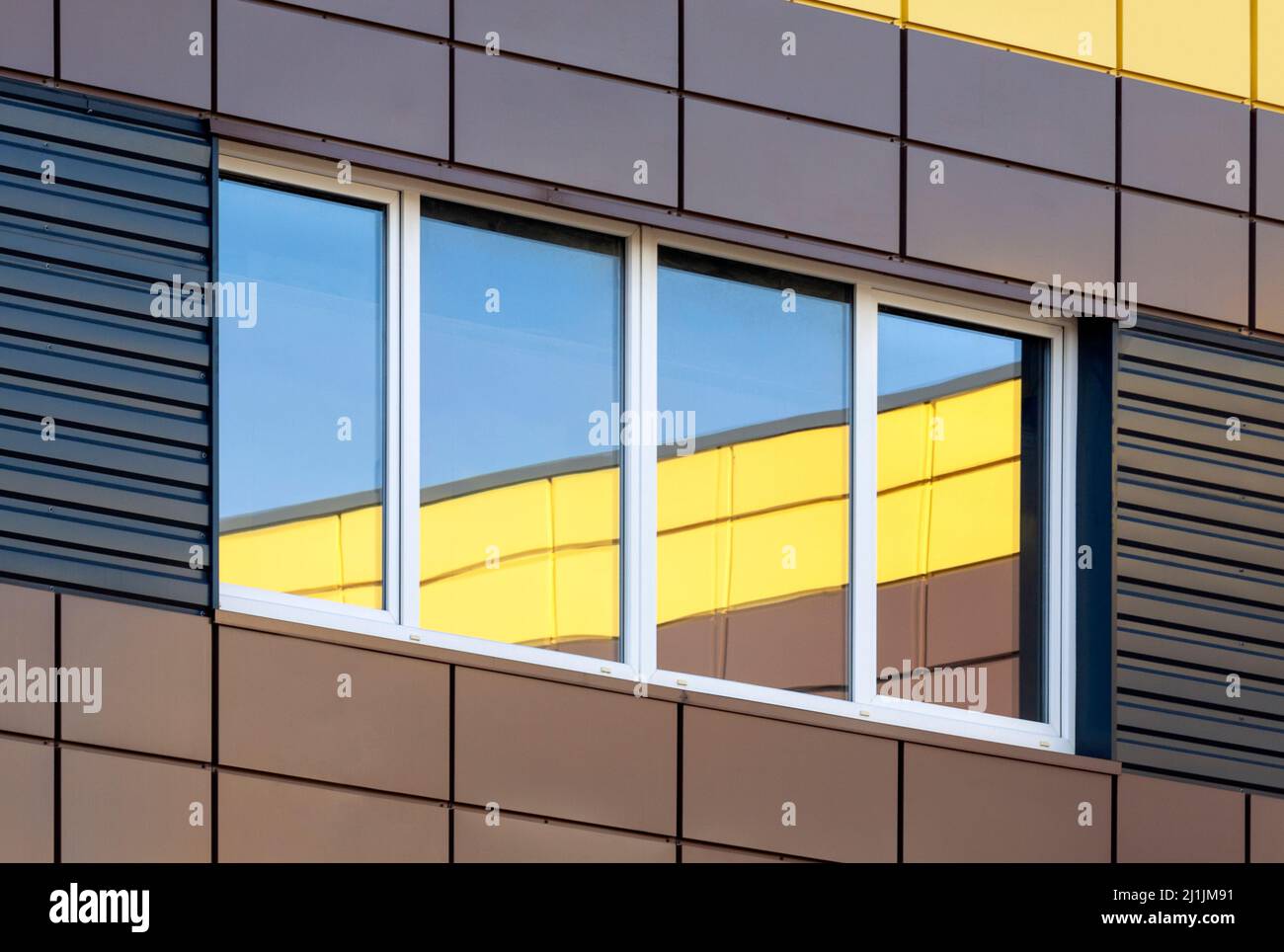 Abstract modern building exterior with colorful window reflection, contemporary architecture Stock Photo