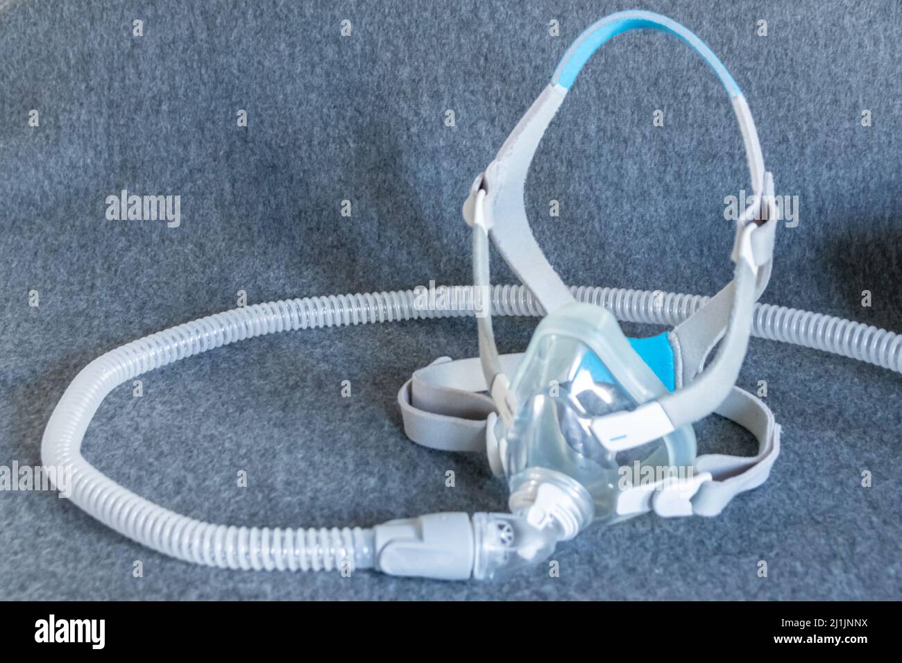 CPAP mask with a full face mask cpap machine against obstructive sleep apnea helps patients as respirator mask and headgear clip breathing medication Stock Photo