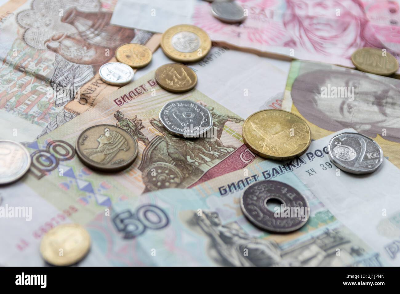 Variety of different bank notes and coins from various countries like euro, pound, emirates money, cyprus bank note and others represent international Stock Photo