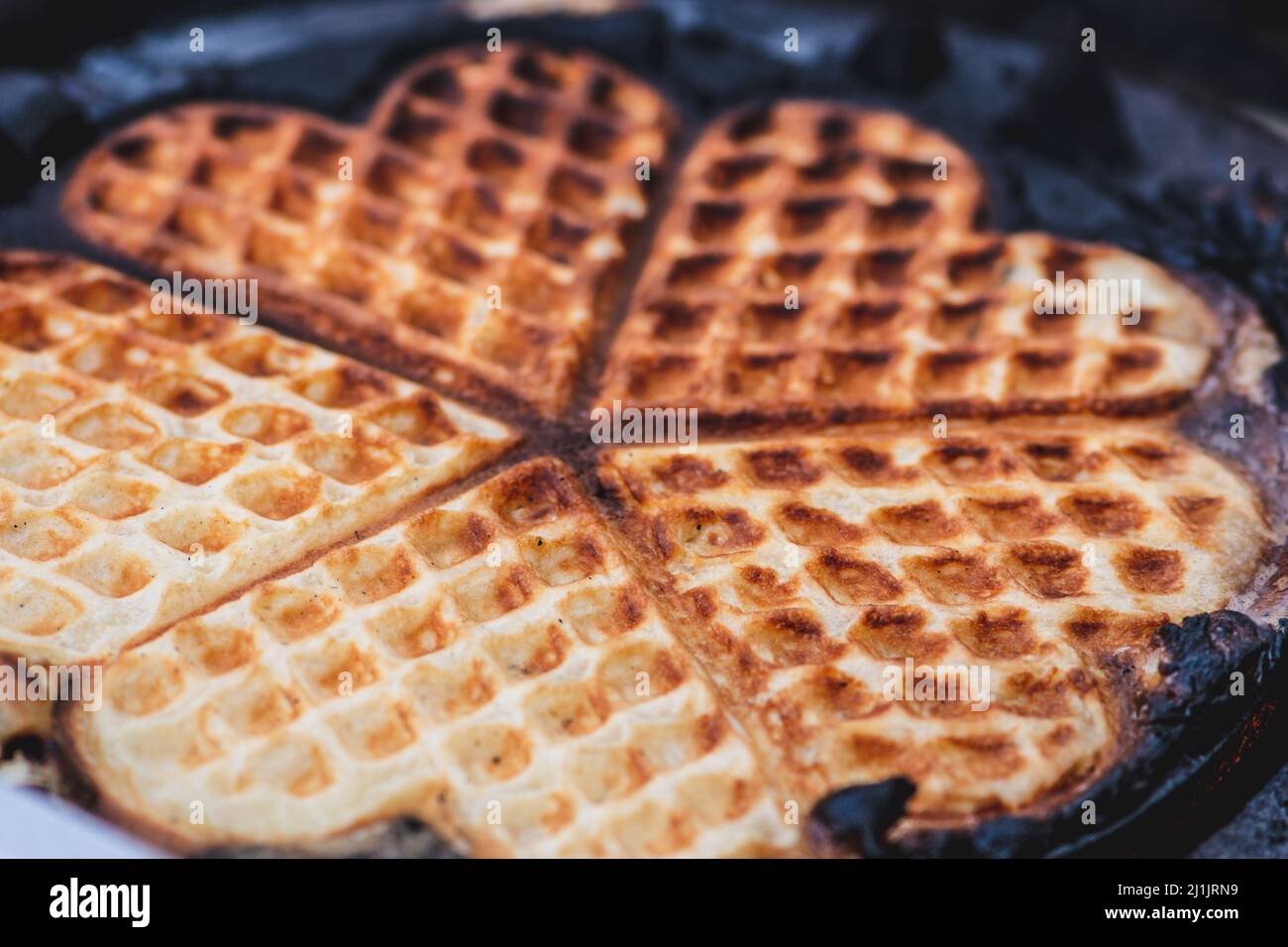 Waffle or waffles in a pan, dish made from leavened batter or dough that is cooked between two plates that are patterned, close up Stock Photo