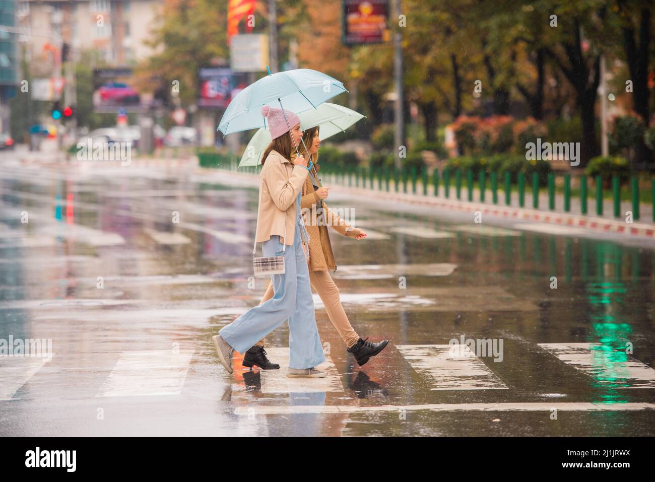 Beautiful and attractive girls are crossing the street together on the ...