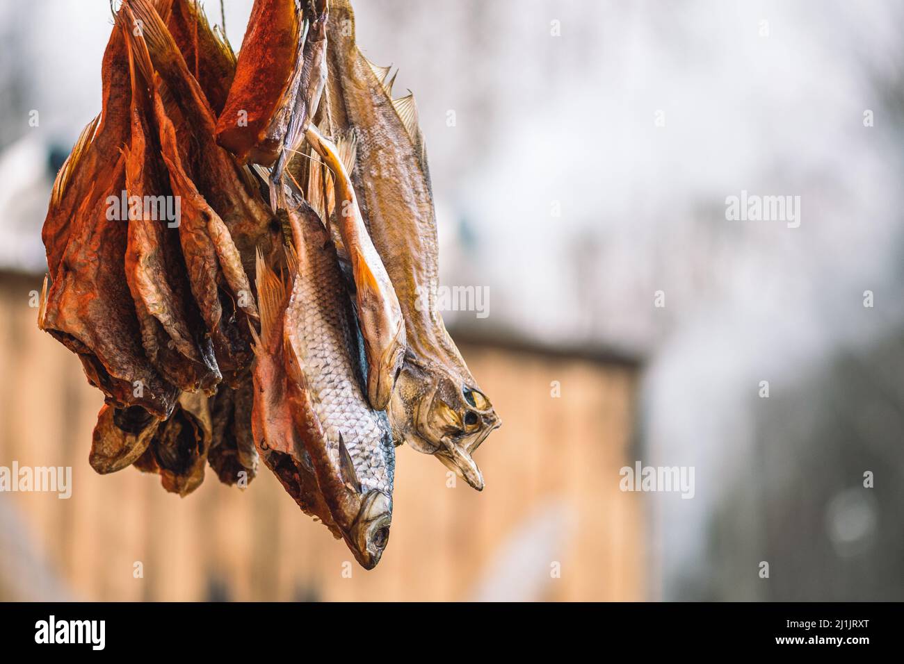 Dry salted fish in a regional street food market with smoke on