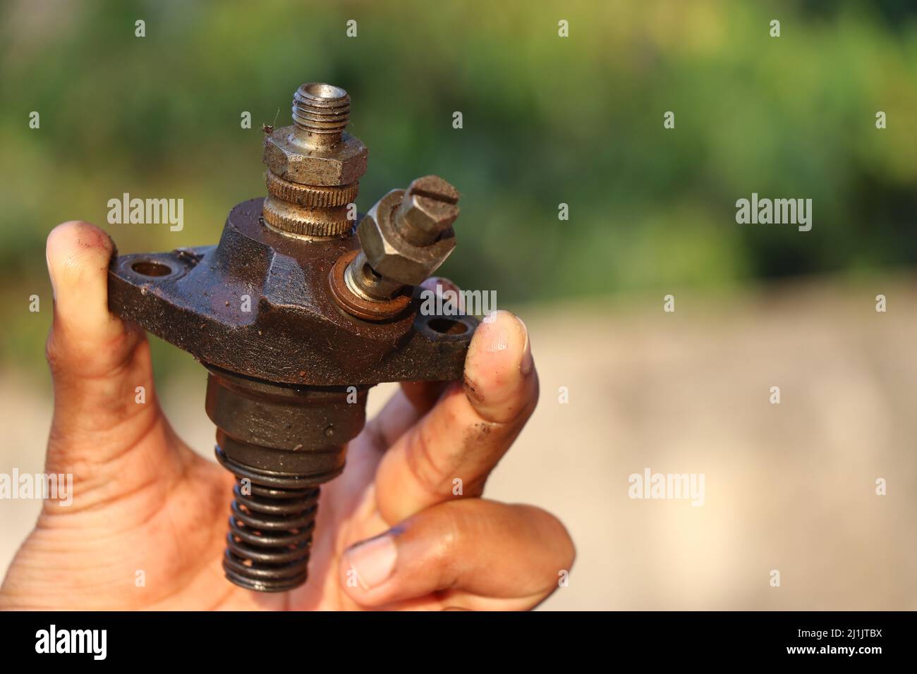 A fuel injector that supplies fuel to the combustion chamber of internal combustion diesel-powered engines held in the hand Stock Photo