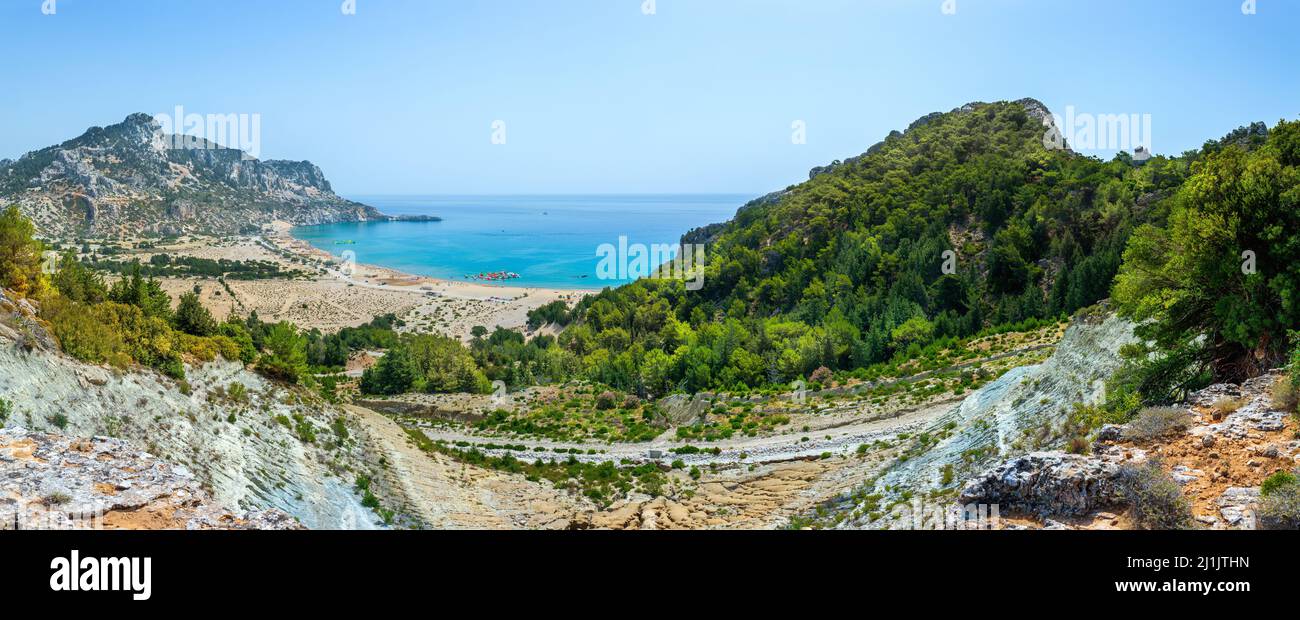 Tsambika Beach in a closed bay. Famous place for beach leisure and multifarious water attraction. Vacation on Greece islands in Aegean and Mediterrane Stock Photo
