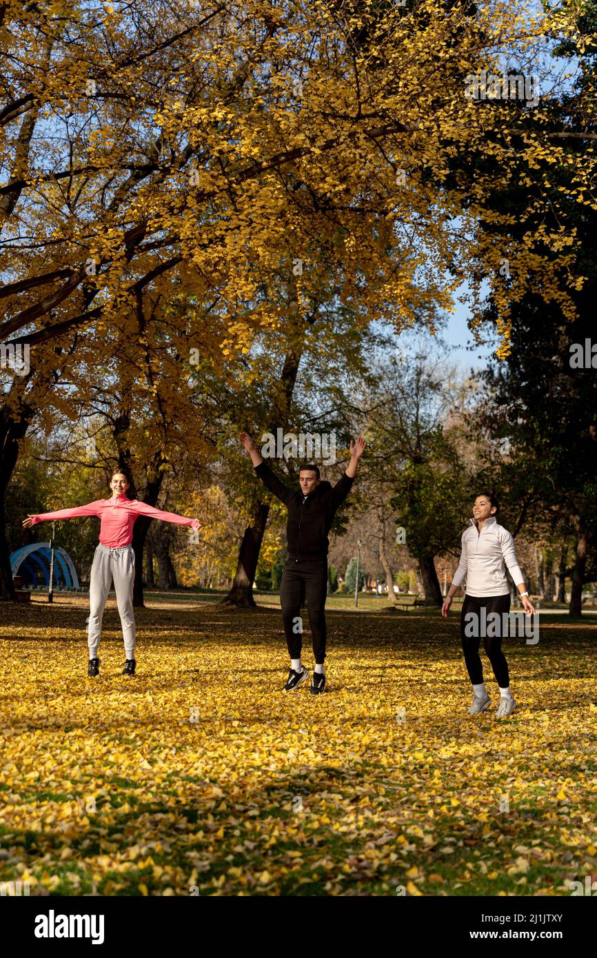 Three amazing and attractive fit friends are doing a jumping jet