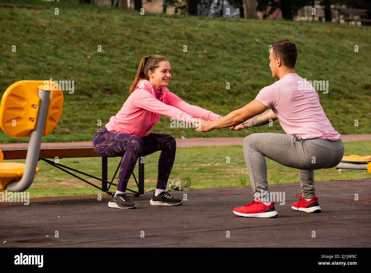 Attractive and beautiful couple is exercising while holding each other ...