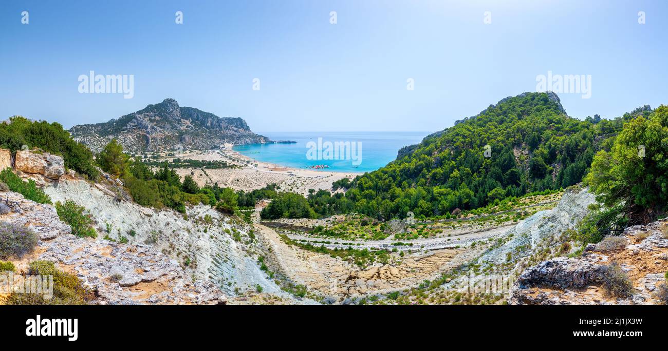 Tsambika Beach in a closed bay. Famous place for beach leisure and multifarious water attraction. Vacation on Greece islands in Aegean and Mediterrane Stock Photo