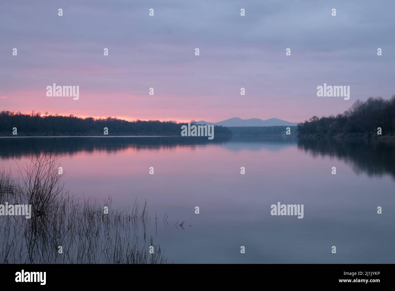 Calm dusk over Sava river with fading light  with mountain in haze - beautiful natural landscape Stock Photo