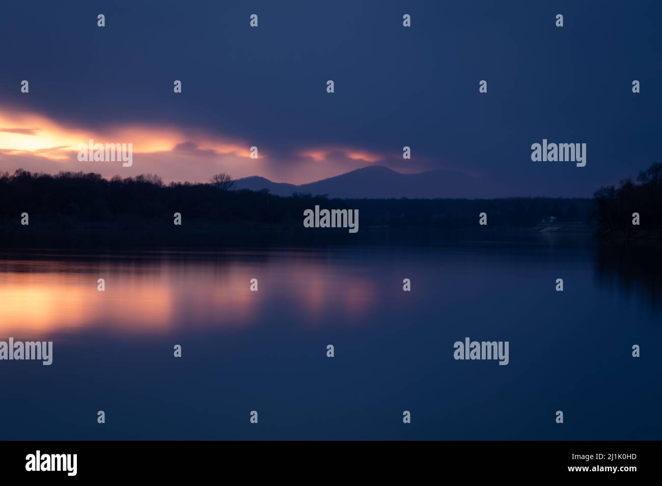 Mountain Motajica obscured by dark clouds at twilight in long exposure - landscape Stock Photo