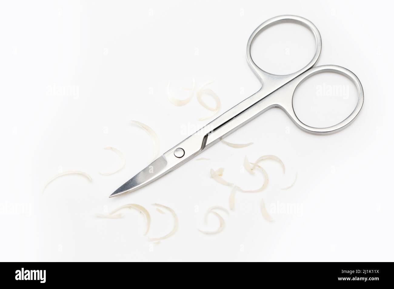 Manicure scissors and nail clipping on white background Stock Photo Alamy