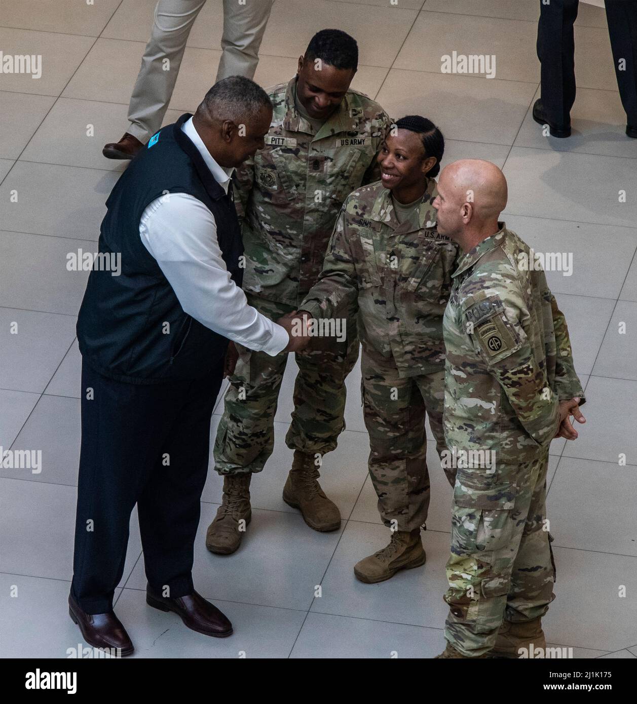 Jasionka, Poland. 25th Mar, 2022. U.S Secretary of Defense Lloyd Austin, left, greets CSM Tonya Sims, center with the 82nd Airborne Division Sustainment Brigade, during a visit with President Joe Biden, March 25, 2022 in Jasionka, Poland. Credit: Sgt. Gerald Holman/U.S. Army/Alamy Live News Stock Photo