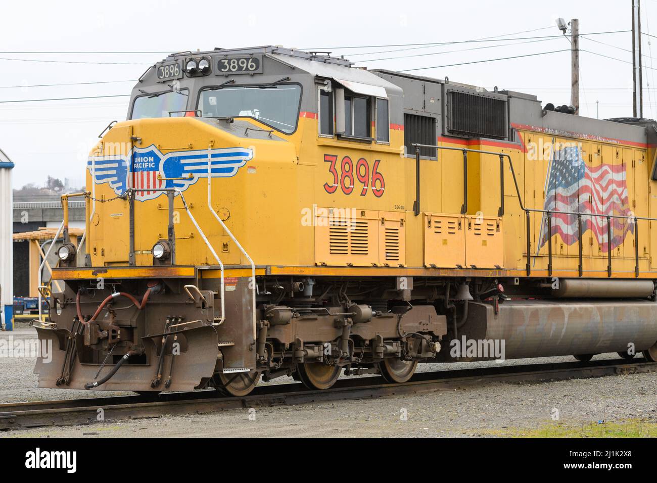Seattle - March 20, 2022; Union Pacific locomotive in yellow with logo and US flag at Seattle Argo Yard, a UP intermodal freight facility Stock Photo