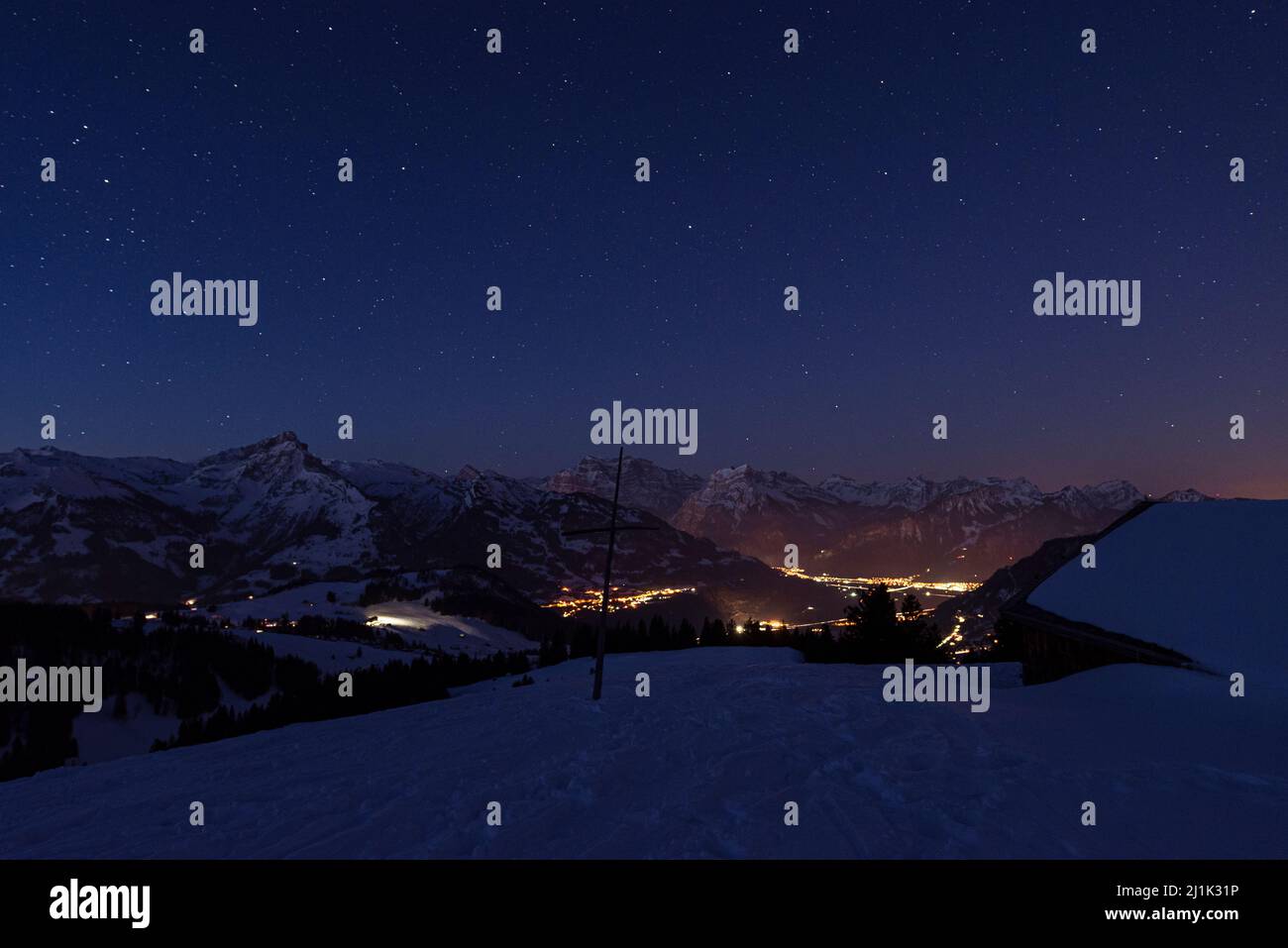 Starry sky ovcer the snowcovered mountain peaks of the Glarus Alps in