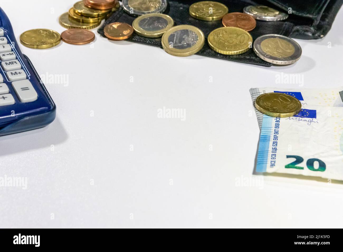 European money with black wallet on white desk as white background with different euro coins and euro bank notes with calculator financial management Stock Photo