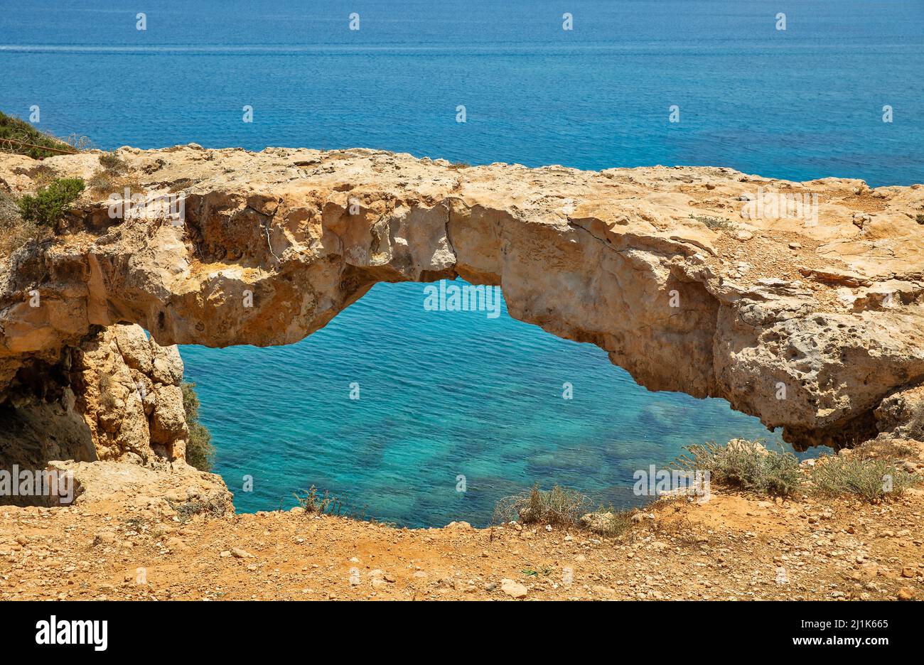 Seascape with Lovers' Bridge or Raven's Arch on Cape Greco peninsula park, Cyprus. It is mountainous peninsula with a national park, rock paths, a tur Stock Photo