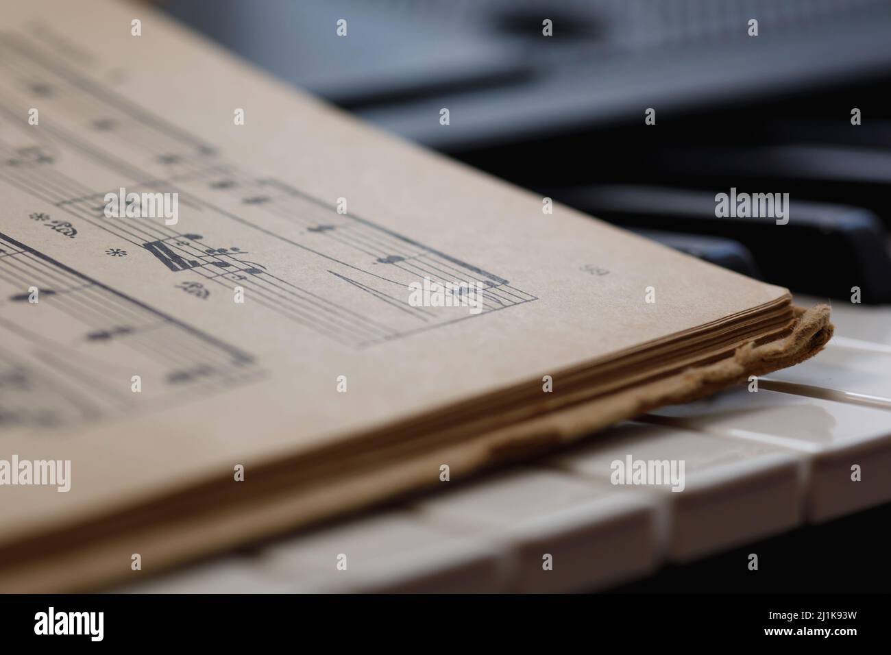 Close up of sheet music on the piano keys Stock Photo - Alamy
