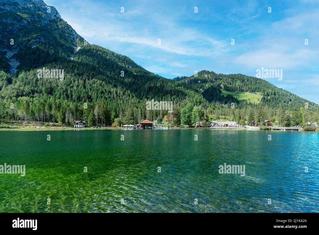 The green waters of mountain Lake Dobbiaco in the italian dolomite alps Stock Photo