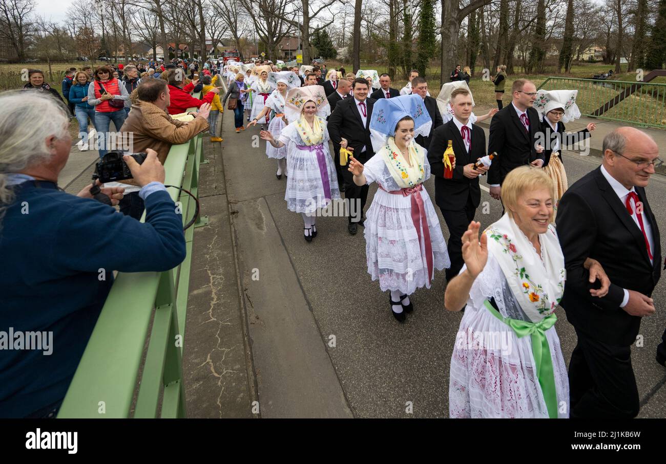 Burg, Germany. 26th Mar, 2022. Participants of the Spreewald Spring Traditional Parade in Lower Serbian traditional costumes walk along the streets, greeting the spectators at the roadside. Credit: Monika Skolimowska/dpa-Zentralbild/dpa/Alamy Live News Stock Photo