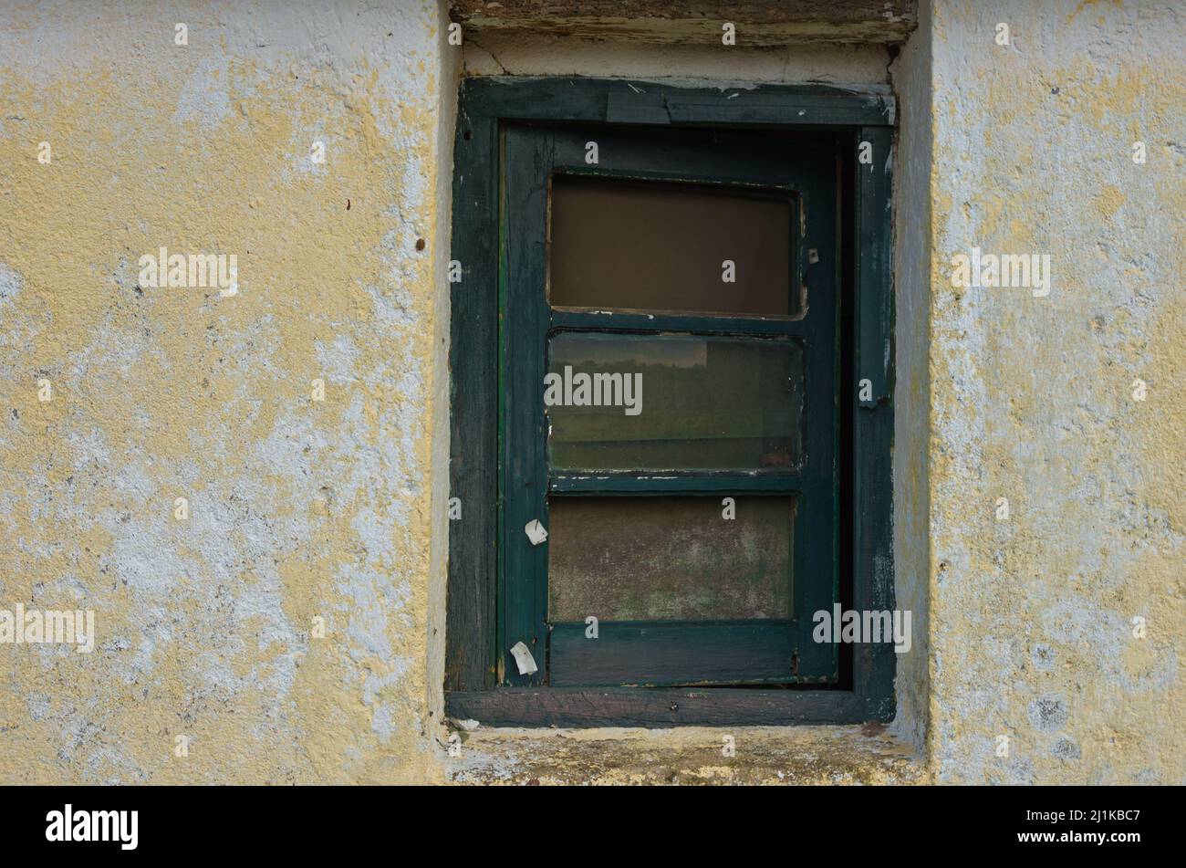 An old window with peeled green frame in a plastered wall Stock Photo ...