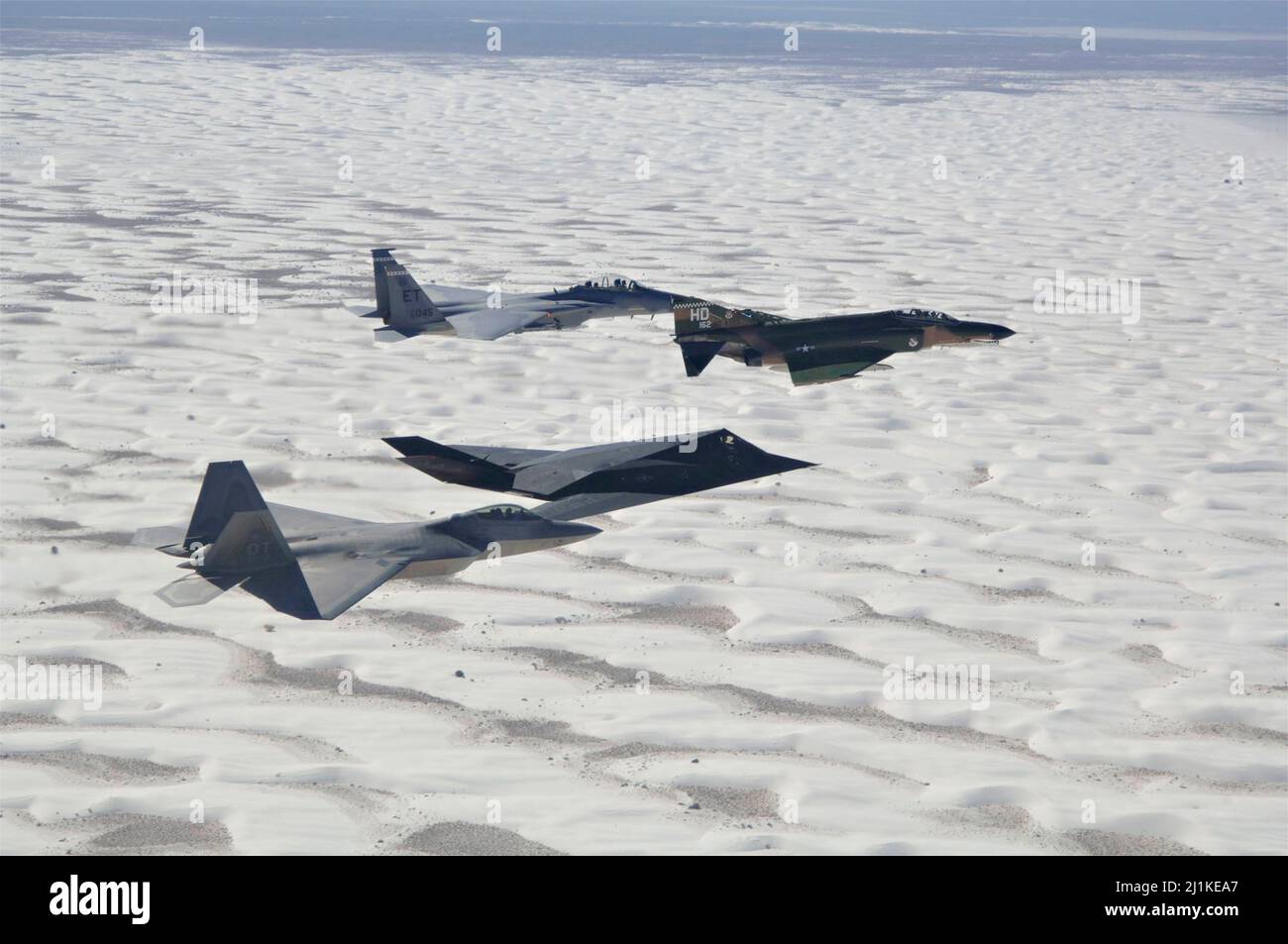 Holloman Air Force Base, United States. 27 October, 2007. A U.S. Air Force F-15 Eagle, F-4 Phantom, F-117 Nighthawk, and F-22 Raptor fighter aircraft fly in formation above the White Sands during the Air and Space Expo at Holloman Air Force Base, October 27, 2007 in Alamogordo, New Mexico.  Credit: SrA Russell Scalf/US Air Force/Alamy Live News Stock Photo