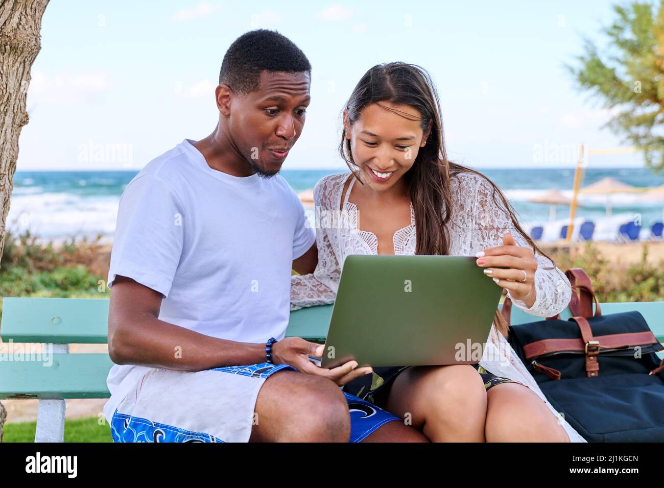 Surprised young couple looking at laptop screen. Stock Photo
