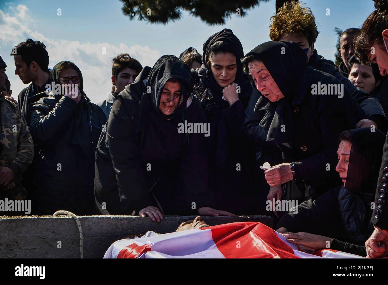 Tbilisi, Georgia. 26th Mar, 2022. Mother and family members mourn near the body of the fallen soldier during the funeral ceremony. A farewell ceremony was held for David Beriashvili, a soldier who was shot dead in defence of Ukraine against the Russian attack, the funeral ceremony was held in central church of Tbilisi, Georgia where many gathered to support the soldier's family. Credit: SOPA Images Limited/Alamy Live News Stock Photo