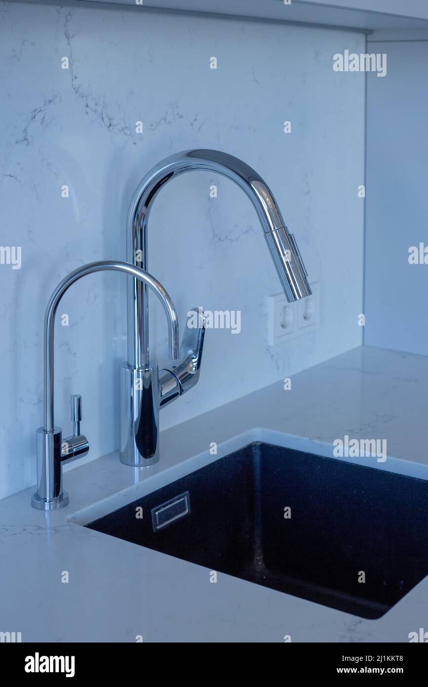 Silvery faucet and kitchen sink on modern kitchen Stock Photo Alamy