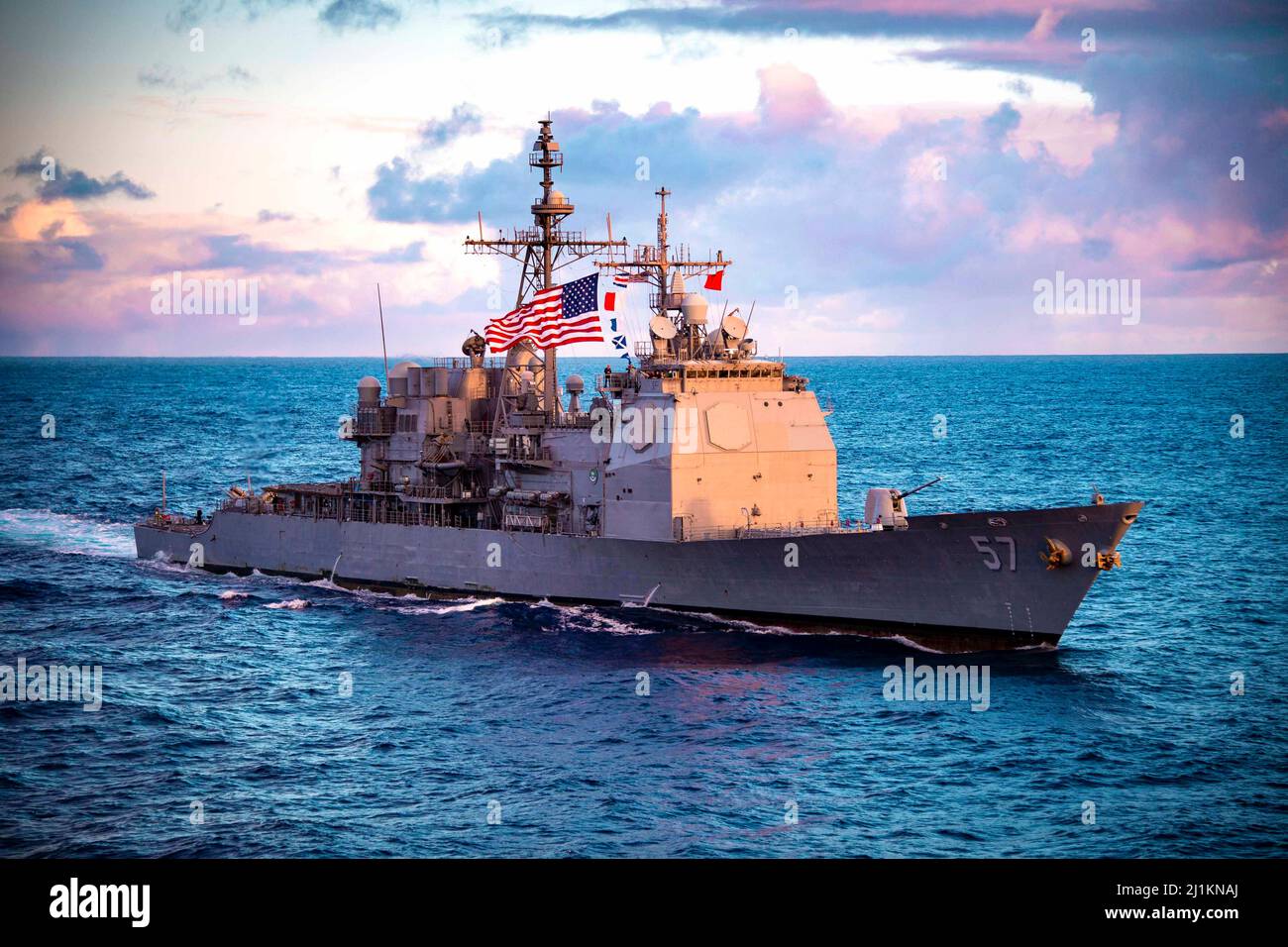 Pacific Ocean, United States. 09 February, 2022. The U.S. Navy Ticonderoga-class guided-missile cruiser USS Lake Champlain during an ocean transit at sunset, February 9, 2022 in the Pacific Ocean.  Credit: MC2 Haydn N. Smith/Planetpix/Alamy Live News Stock Photo