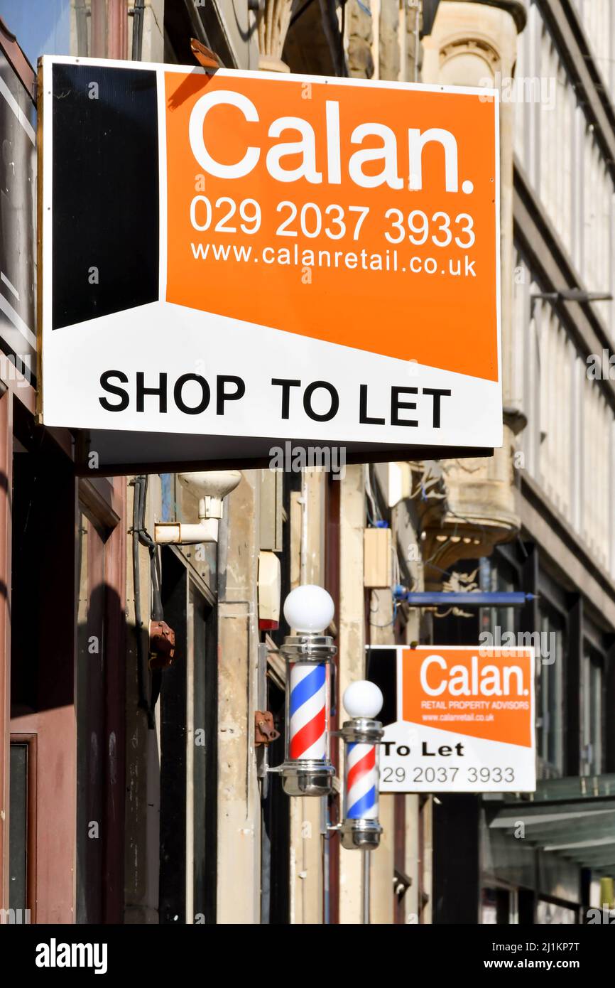 Cardiff, Wales - March 2022: Signs on the outside of a building in Cardiff city centre advertising empty shops to let Stock Photo