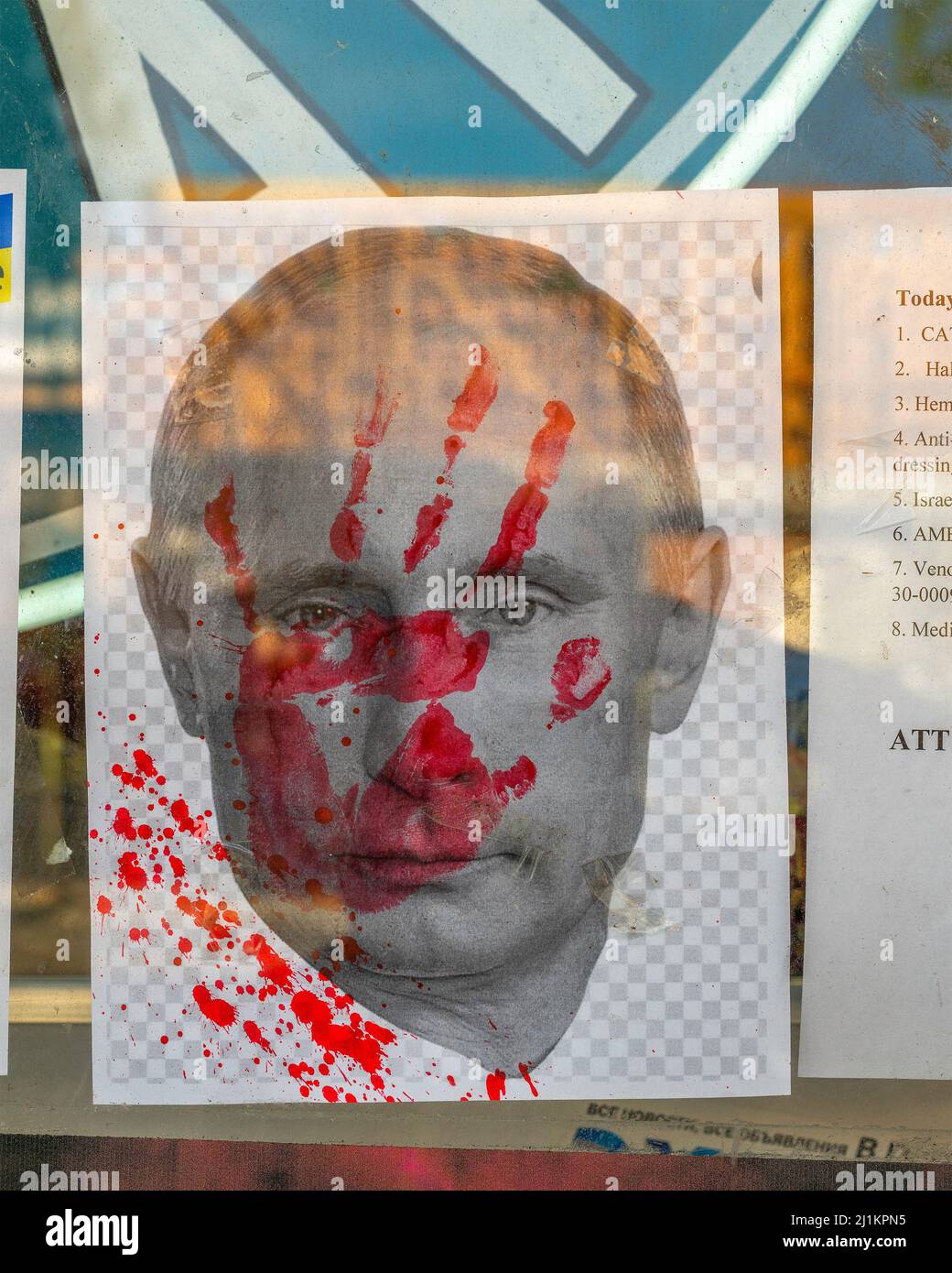West Hollywood, CA, USA - March 26, 2022: Close up of a Ukrainian store window with a picture of Vladimir Putin with a red handprint on his face, West Stock Photo