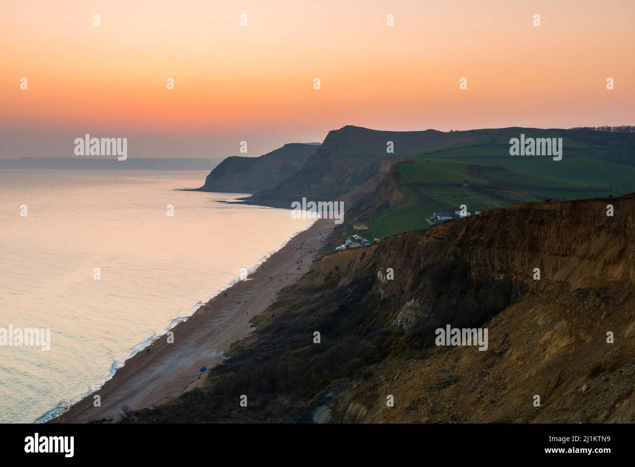 Eype, Dorset, UK. 26th March 2022. UK Weather. The sky glows orange at ...