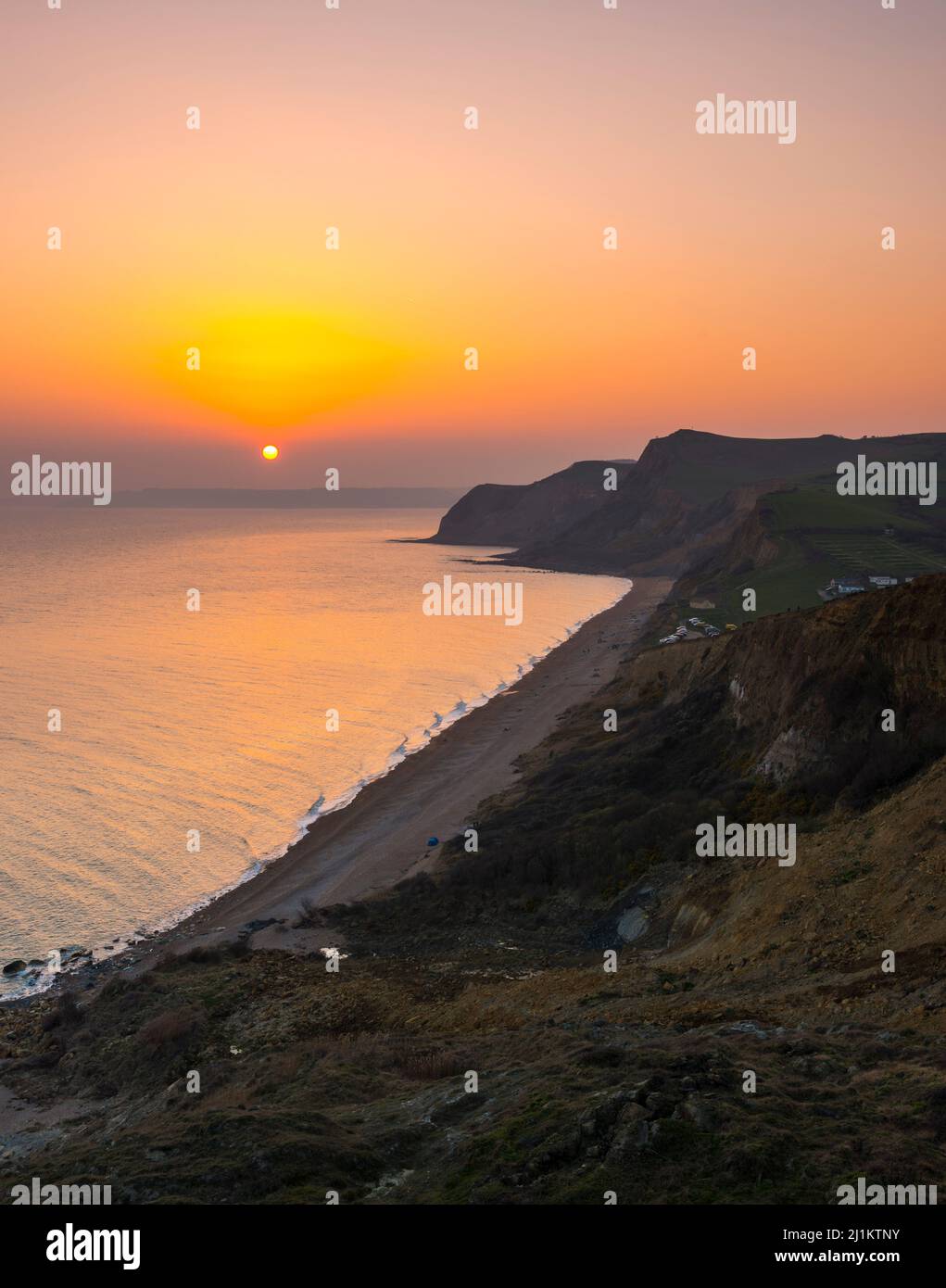 Eype, Dorset, UK. 26th March 2022. UK Weather. The sky glows orange at ...