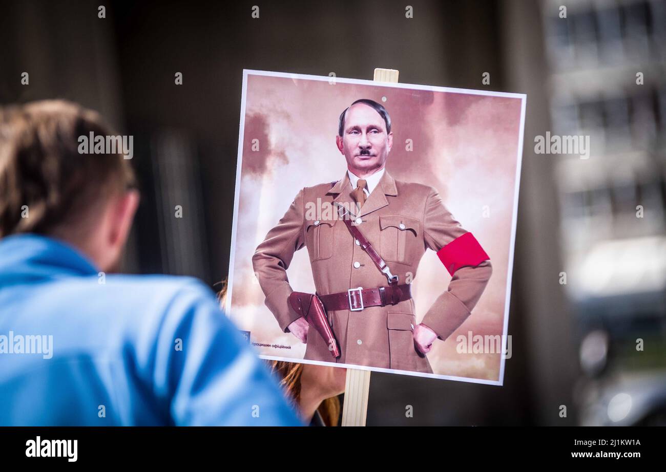 Munich, Bavaria, Germany. 26th Mar, 2022. A photoshop of Putin as Hitler as seen at a demo against the Ukraine war in Munich, Germany. After a month of brutal warfare where Russia has chosen to destroy entire cities such as Mariupol when they don't surrender, Ukrainians, Germans, Russians, and Belarusians are demanding consequential action from the German government who has been discovered to largely not participate in sanctions against oligarchs and other figures, leading to more calls that the country is a ''puppet state'' of Putin's. (Credit Image: © Sachelle Babbar/ZUMA Press Wire) Stock Photo
