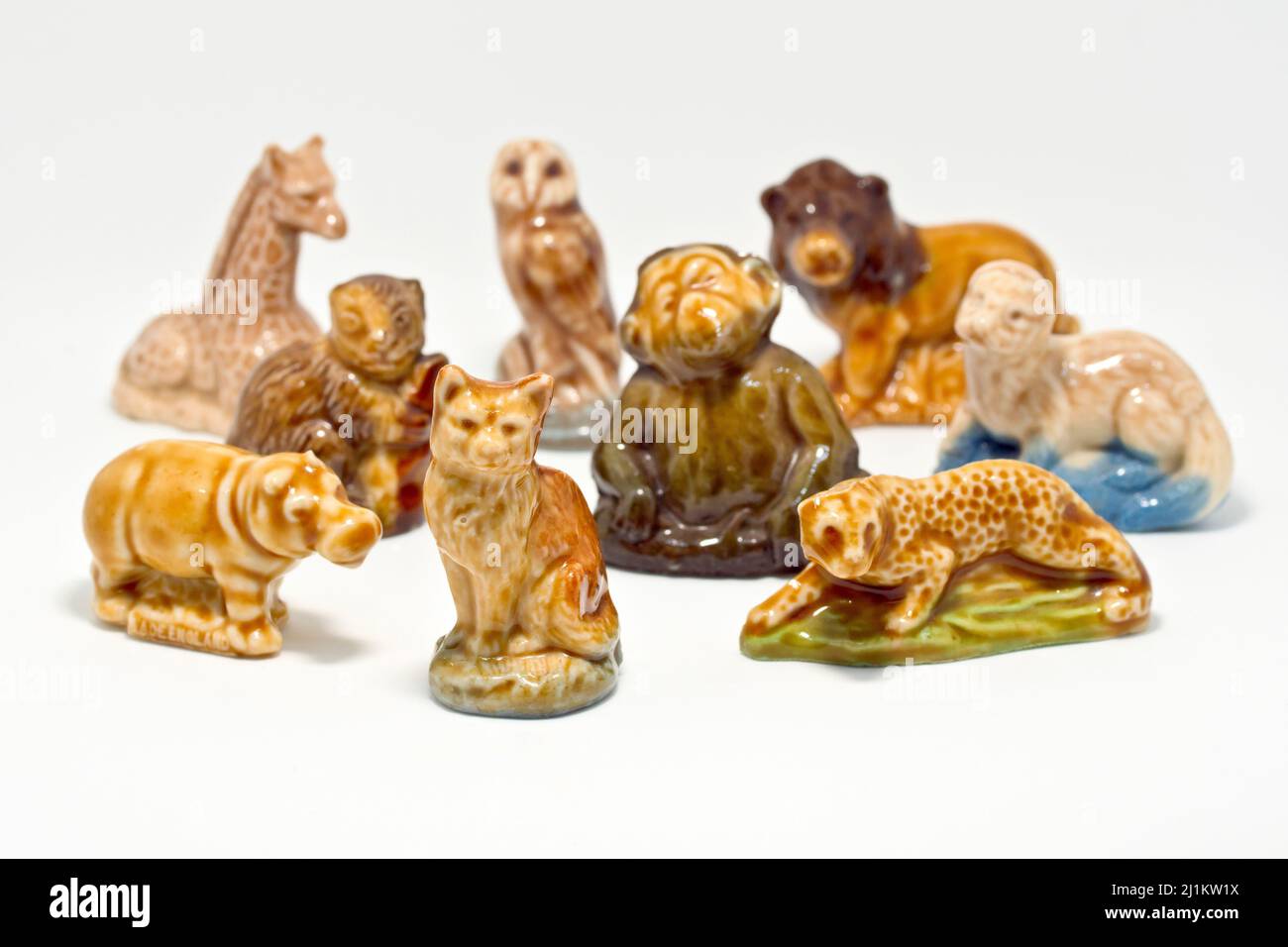 Close up of a collection of Wade Whimsies, small porcelain animal figurines popular with collectors since the 1950s, against a white background. Stock Photo